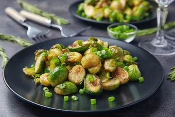 Plate with roasted brussel sprouts on table