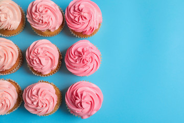 Many yummy cupcakes on color background