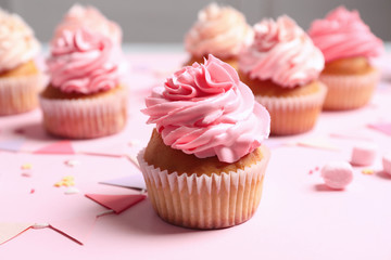 Many yummy cupcakes on table