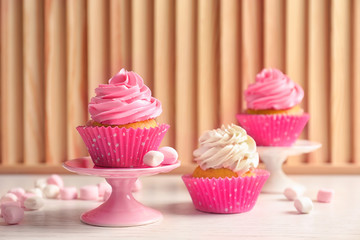 Yummy cupcakes on wooden table