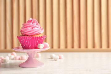 Yummy cupcake on wooden table