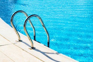 Steps with handrails in the blue pool