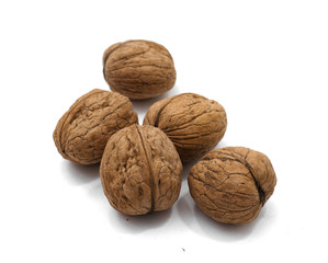 several walnuts in shell on white background