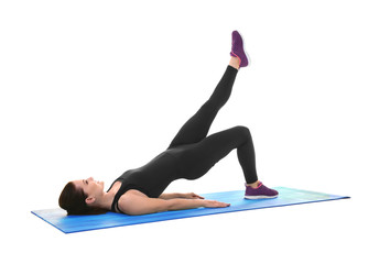 Young sporty woman doing exercise on white background