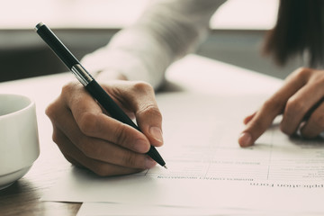 Closeup of Woman Completing Application Form