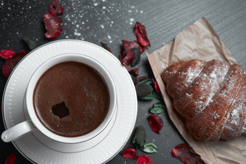 Fresh croissant on a black slate background. Top view