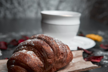 coffee and croissants on black background
