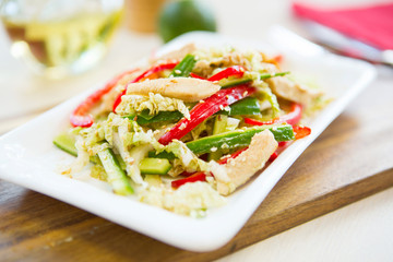 Homemade Vegetable salad on a plate on wooden cutting board