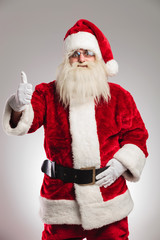 portrait of a positive santa claus making the thumbs up