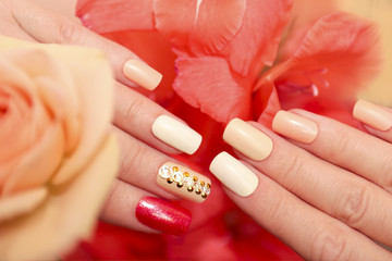 Multi-colored pastel nail design for different square and oval shaped nails on female hand close up.