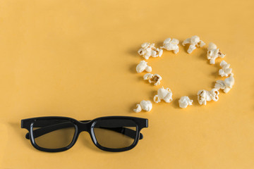 3d glasses and a think/speech bubble of popcorn on a yellow background.