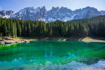 Beautiful view alpine lake with mountains in the Dolomites in South Tyrol, Italy.  Lago di Carezza, Karersee.