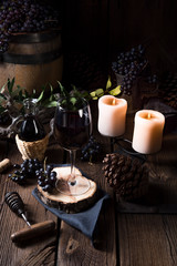 Red wine from a barrel with grapes and a glass of wine
