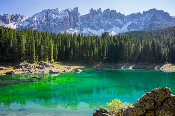 Beautiful view alpine lake with mountains in the Dolomites in South Tyrol, Italy.  Lago di Carezza, Karersee.