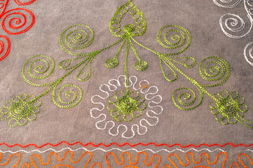 Texture, background, pattern. Cloth of cotton with embroidery of colors and patterns. Clear color...
