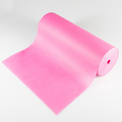 roll of pink colored wrapping foil isolated on white background