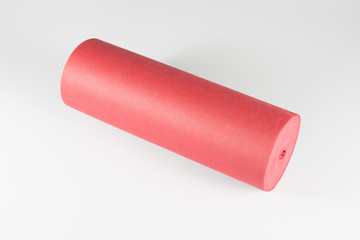 Roll of red colored wrapping foil on white background