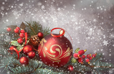 Festive background with Christmas tree twigs decorated with red baubles and fir twigs