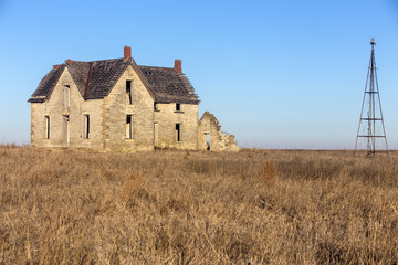 Fototapeta abandoned stone house of Dr. William B. Jones near Florence, Kansas; partial windmill obraz