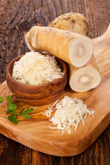 Fresh Horseradish on wooden table