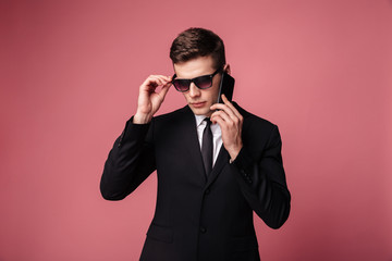 Handsome young businessman standing isolated