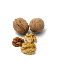 several whole and chopped walnuts on a white background