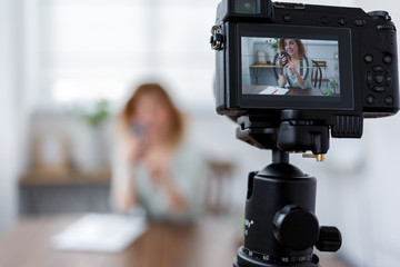 Blurred photo of female blogger with phone