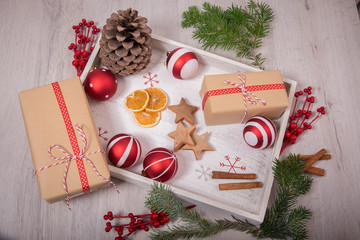 Christmas gift and ornaments with pine tree over a wood background