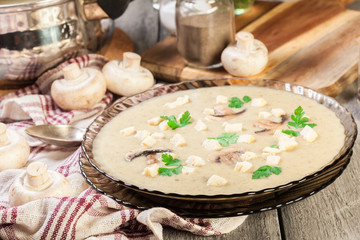 Mushroom cream soup with croutons and spices