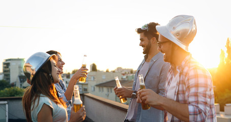 Group of happy friends having party on rooftop