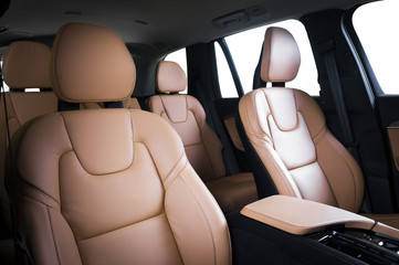 Luxury car inside. Interior of prestige modern car. Comfortable leather seats. Red perforarated...