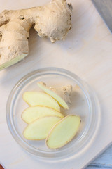 Ginger root slices on transparent glass plate.
