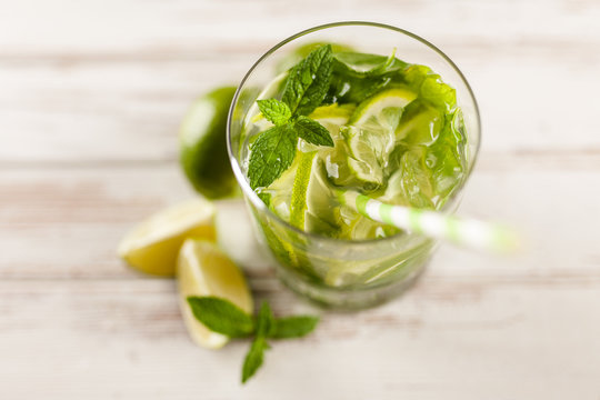 Mojito cocktail on white wood background