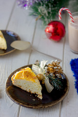 Piece of christmas cake ready to eat on rustic plate.