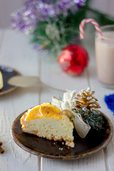 Piece of christmas cake ready to eat on rustic plate.