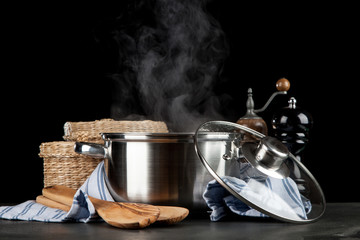 Steaming pot on black background