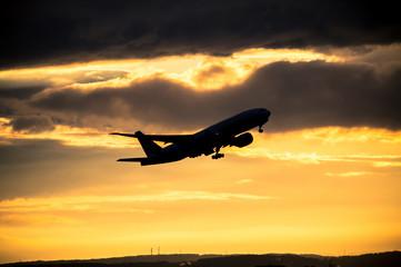 Silhouette of airplane at sunset...