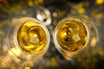 Two champagne glasses in golden glitter