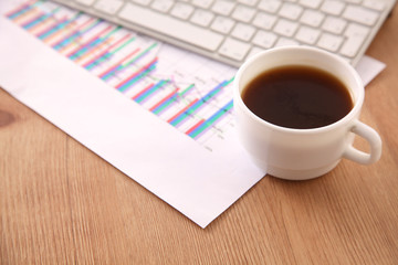 Office table with blank notepad and laptop