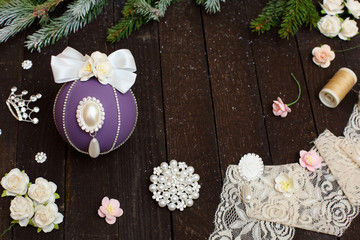 Christmas balls with bows and rhinestones on a wooden background