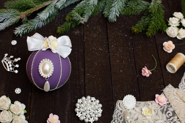 Christmas balls with bows and rhinestones on a wooden background