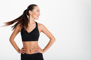Portrait of a smiling asian fitness girl standing