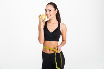 Fototapeta na wymiar Portrait of a healthy asian fitness woman holding apple