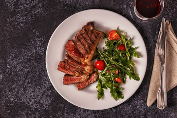 Beef steak on a dark background.