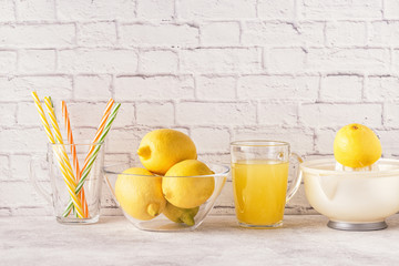 Lemons and juicer for making lemon juice.