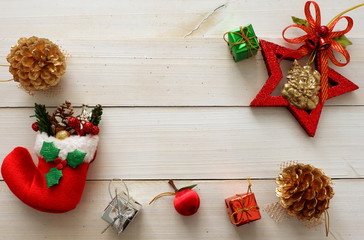  Christmas background with red sock,gift box,pine,candy on wooden white background  ,top view for copy space