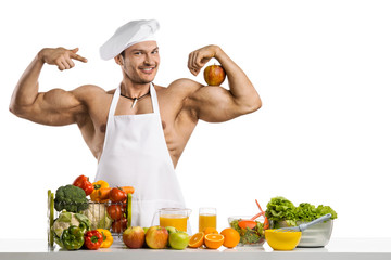 Man bodybuilder cook with apple on biceps
