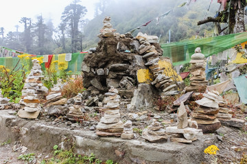 Stack of prayer stones in pyramid form symbolizing zen, harmony and balance commonly found around Bhutan Dzong.