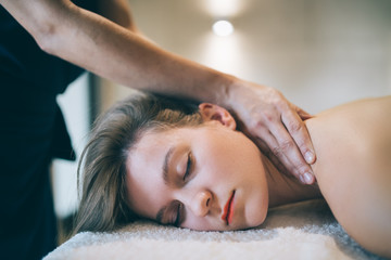Fototapeta na wymiar Masseur treating patient with therapeutic massage