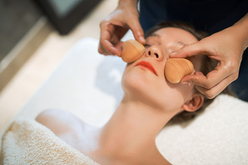 Obraz na płótnie Canvas Massage therapist using wooden tool to massage patient